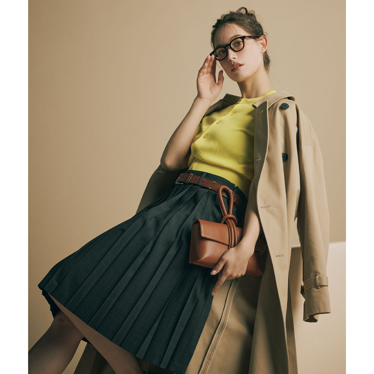 イエローカーデにトレンチコートのコーデ