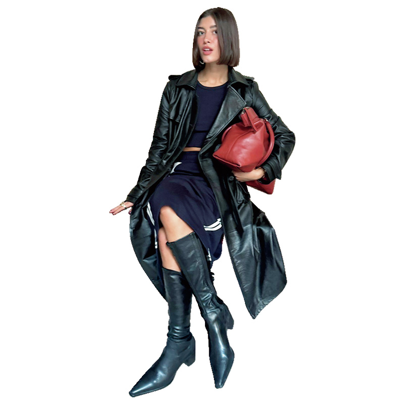 レザージャケットとロングブーツで決めている女性